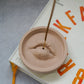 Lip Incense Holder with incense stick on it.