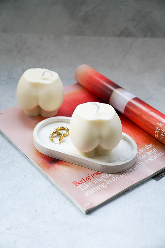 Extra Large Bottom Candles in a trinket dish on a magazine.