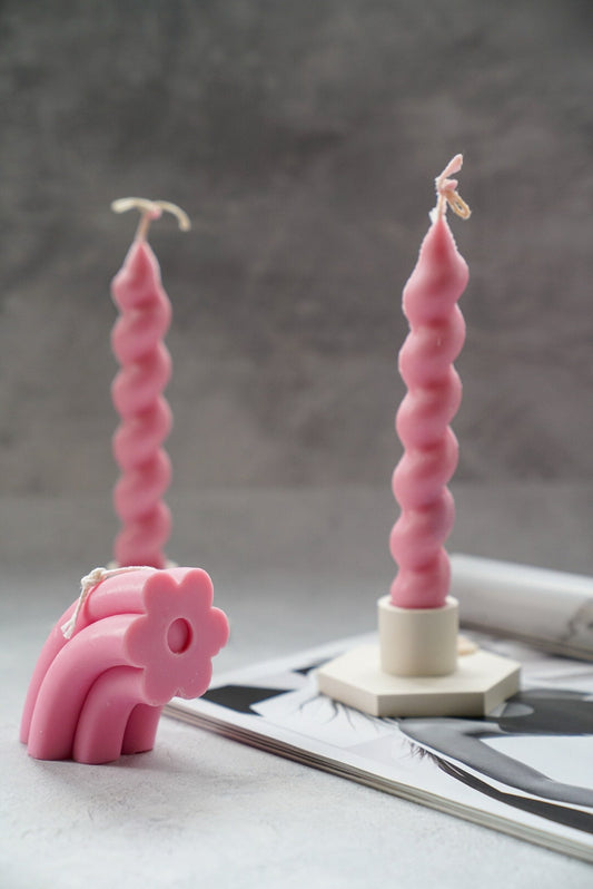 Pink Daisy Flower Arch Candle with Twisted candle on the background.